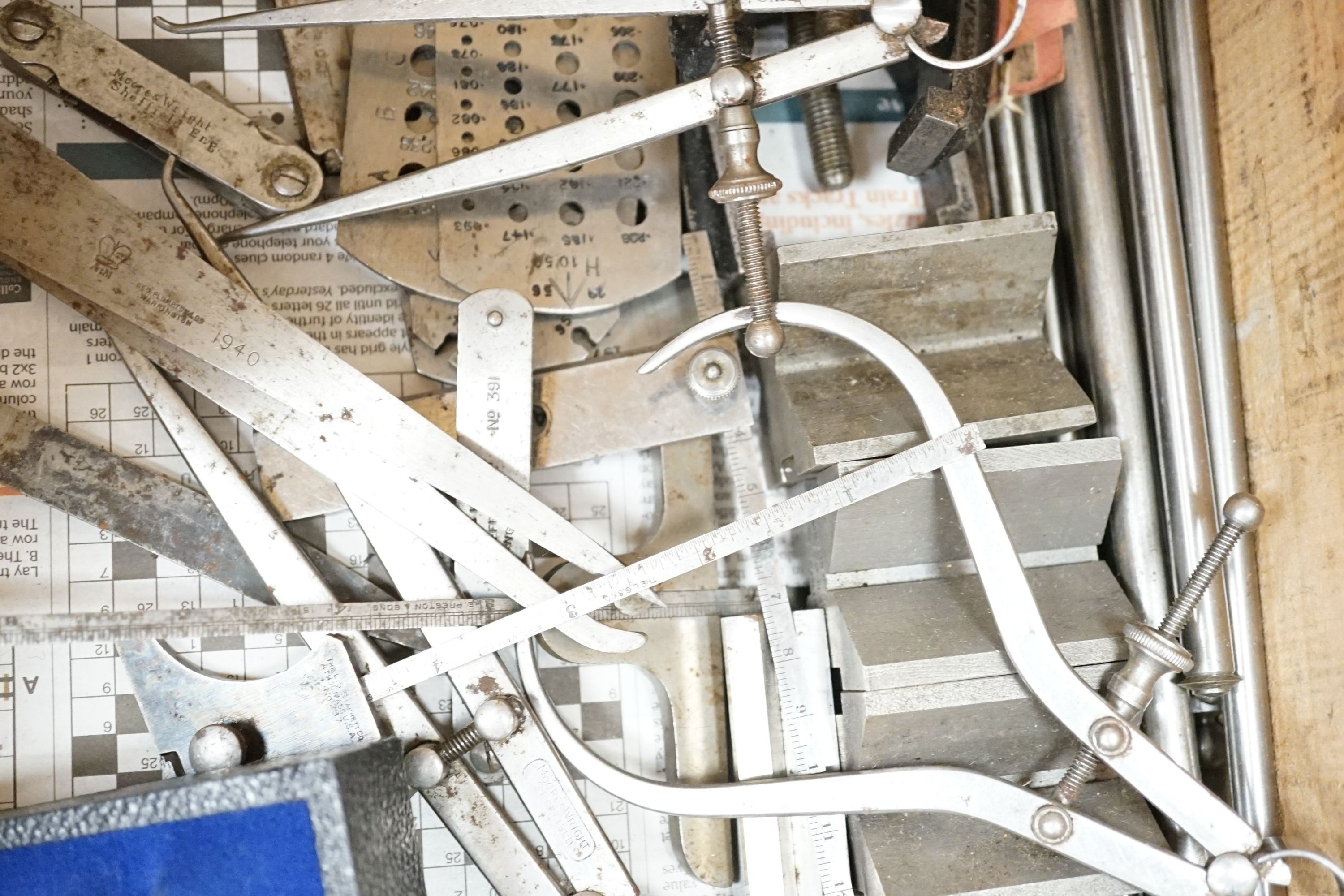 A collection of 20th century high precision metal measuring devices, including callipers, Compac dial micrometers, feeler gauges, wire gauges, a set square, steel cutting wheels etc